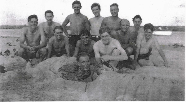 Officers Beach Party taken in 1941 The five at the back - Lieut Peter Arbuthnot, Midshipman Mark Alford Lieut Frank Woodward, Lieut David Cunningham, ?\nThe six in the centre - Midshipman Douglas Holloway, Midshipman Dean, Midshipman David Jay, Midshipman David Houston, Surgeon Cdr Thomas Larkworthy (with bald head), unknown Midshipman\nin Sand car in front with scarf - another unknown Midshipman